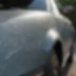 Close-up of a car's scratched paint surface before restoration.