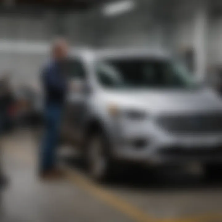 Mechanic inspecting a Ford Escape Hybrid during maintenance