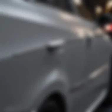 Close-up of a dented car door before repair